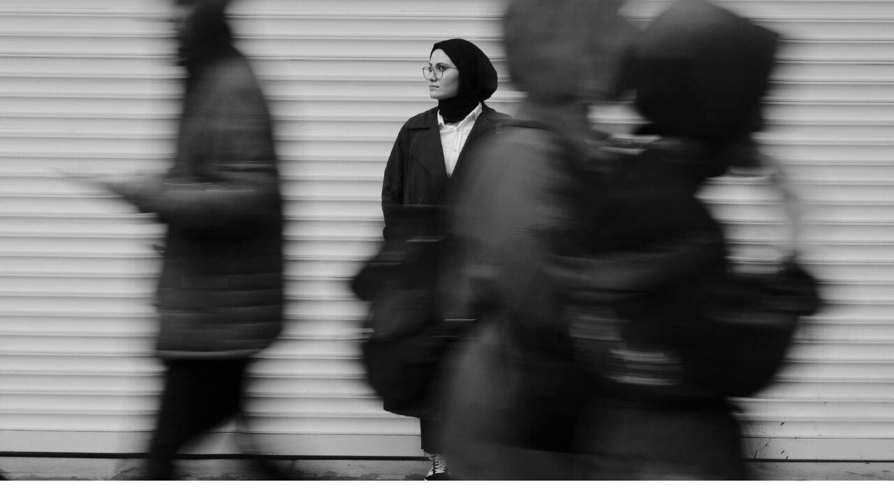 woman with people walking by in a blur